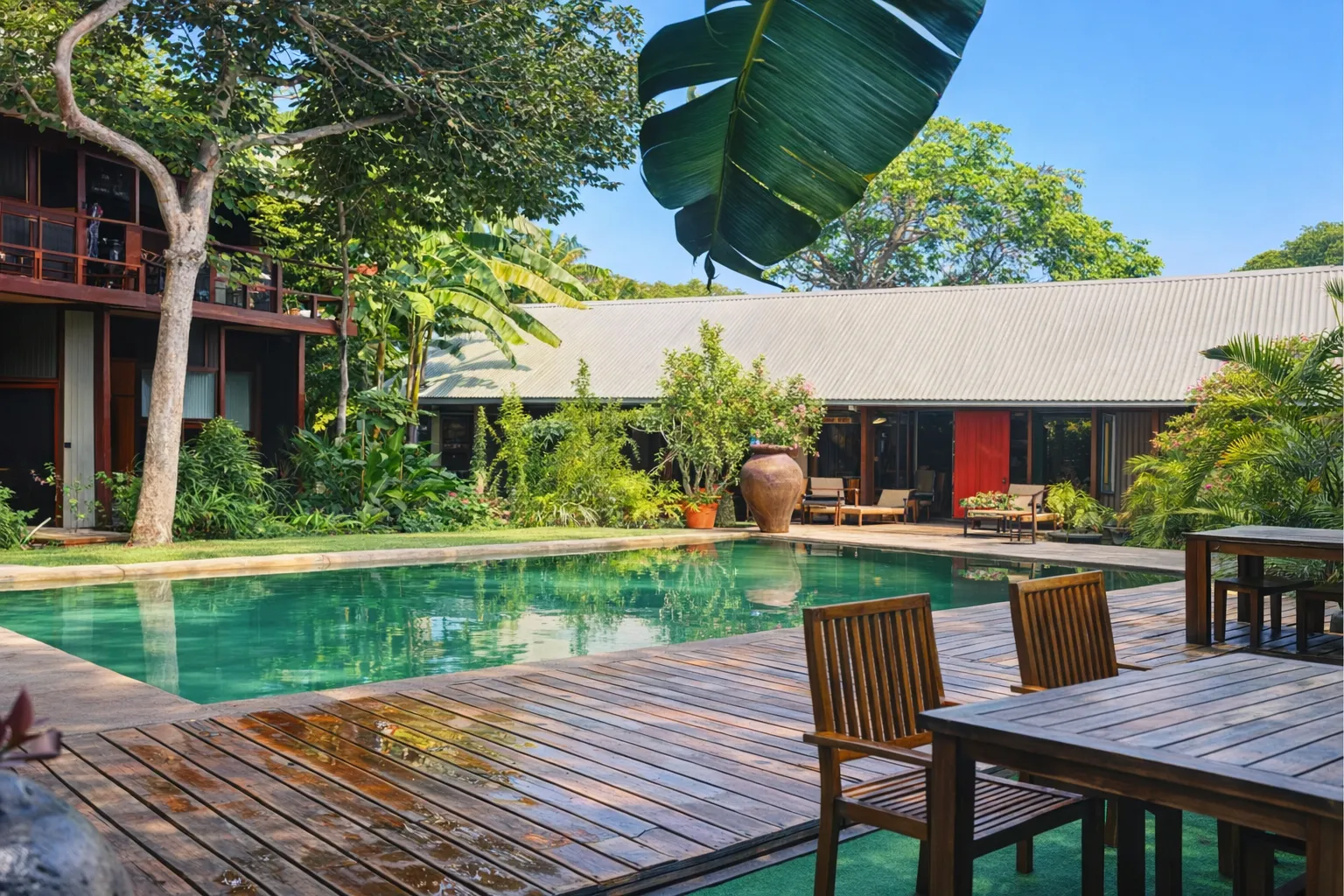 Pool area with banana palms and lush tropical gardens